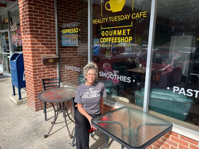 Owner Traci Gregg seated outside her coffee shop, Reality Tuesday Cafe in Northern Kentucky. Gregg says she has until April 30 to come up with more than $13,000 in back rent or face eviction by her landlord.