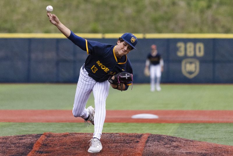 Seth Maybury (13) of the Moeller Crusaders pitches in the fourth inning during a game between Elder and Moeller, Monday, April 27, 2026, at Kremchek Stadium.
