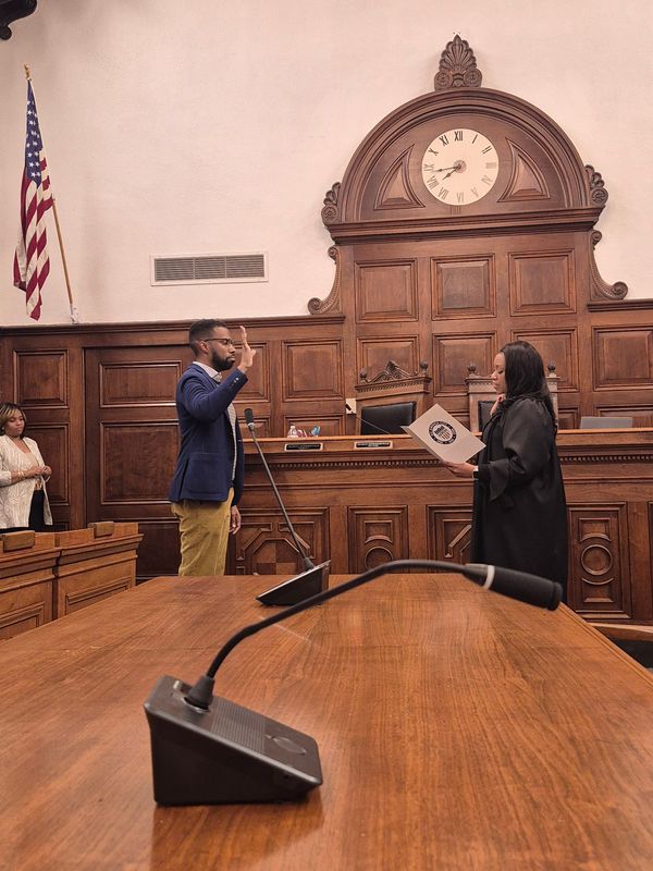 Summit County Domestic Relations Judge Kani Hightower administers the oath of office to Mark Greer on April 27, 2026 after Akron City Council voted to appoint him to the open at-large seat vacated by Jeff Fusco.
