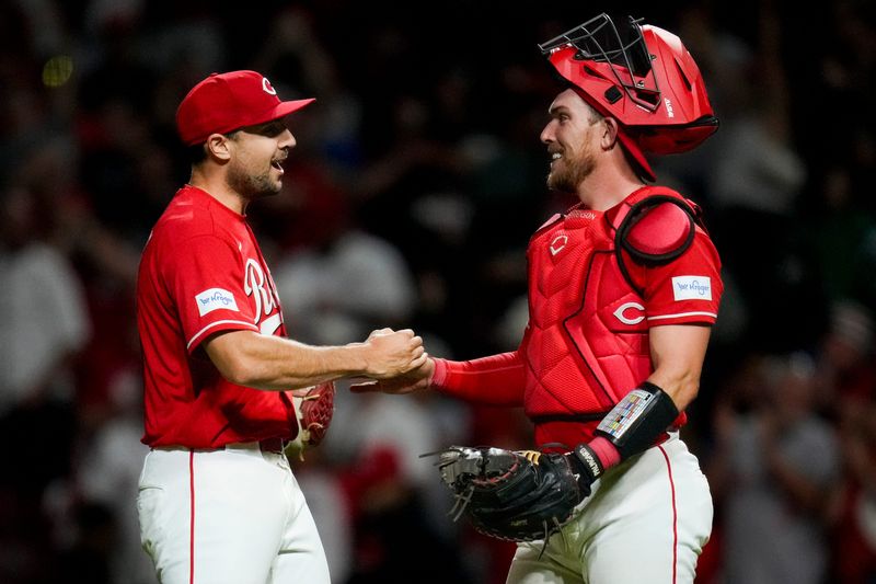 Cincinnati Reds pitcher Brock Burke (49) and catcher Tyler Stephenson (37) secured free pizzas for Reds fans with an 11th strikeout against the Rockies on April 28. The Reds won the game, 7-2.