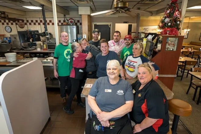 Staff gather for a group photo at the Skyline Chili location on West 3rd Street in Covington on April 24, 2023.