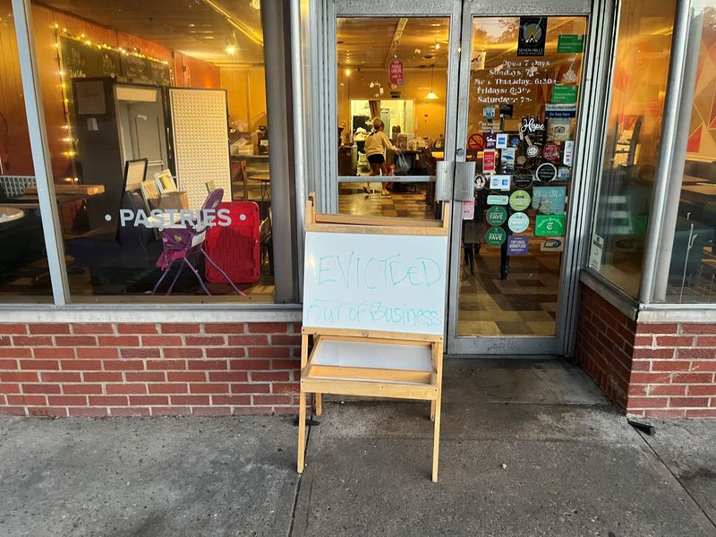 A sign out front of Reality Tuesday Cafe on Thursday read: "EVICTED - OUT OF BUSINESS." Owner Traci Gregg said she's closing the popular neighborhood gathering spot under threat of eviction from her landlord and pressure from mounting operating costs and competition.