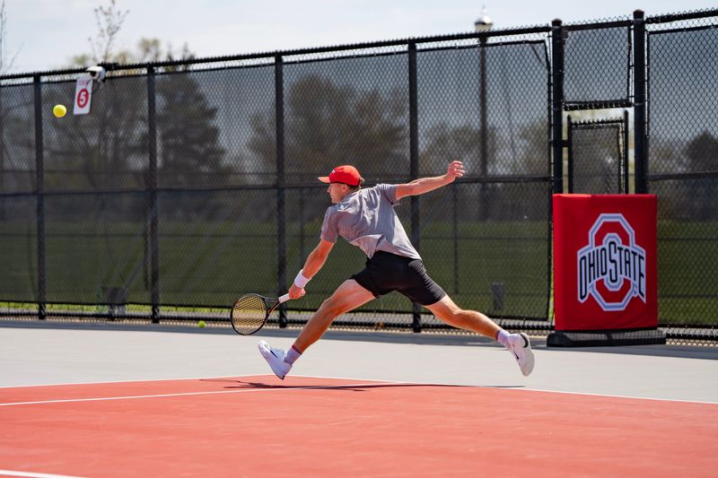 Ohio State men's tennis player Preston Stearns hits a backhand shot.