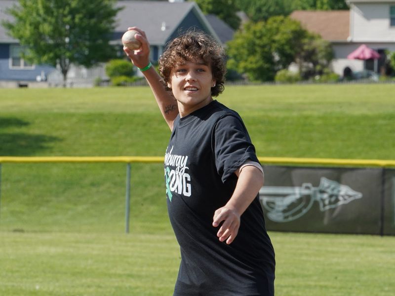 Lebanon senior Zach Amburgy, who was recently diagnosed with a rare form of liver cancer, throws out a ceremonial first pitch before the Warriors' game against Kings.