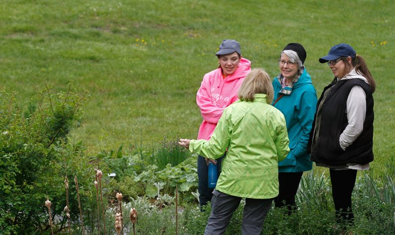 Three generations of plant enthusiasts - Marge Zwolinski, her grandmother Gladys Cannon, and her mom Jennifer Cannon - listen closely as Peggy O'Connor, executive director of the Gilbert Stuart Birthplace and Museum in Saunderstown, gives a tour of the herb garden on Mother's Day.