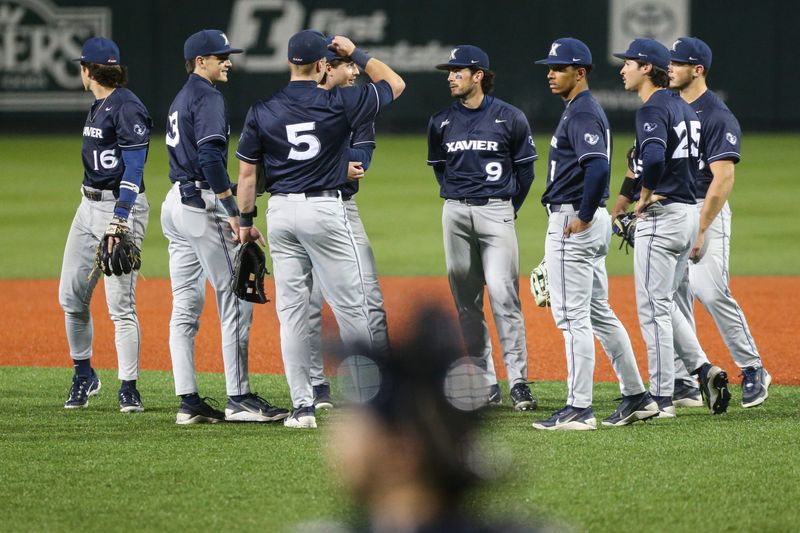 The Xavier baseball team meets during a replay review in an NCAA college baseball game at Goss Stadium on Friday, March 6, 2026, in Corvallis, Ore.