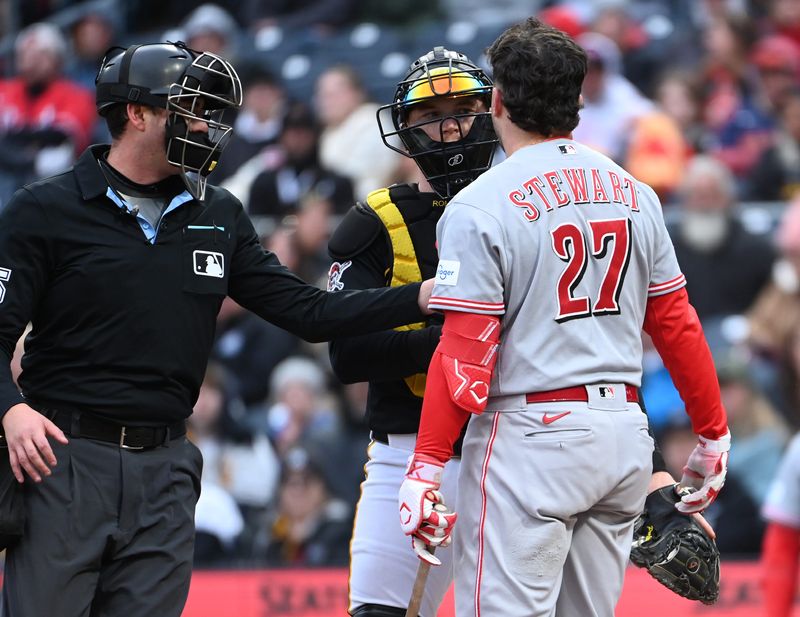 Home plate umpire Willie Traynow keeps Reds second baseman Sal Stewart away from catcher Henry Davis after he was nearly hit by the ball during the seventh inning at PNC Park May 2.