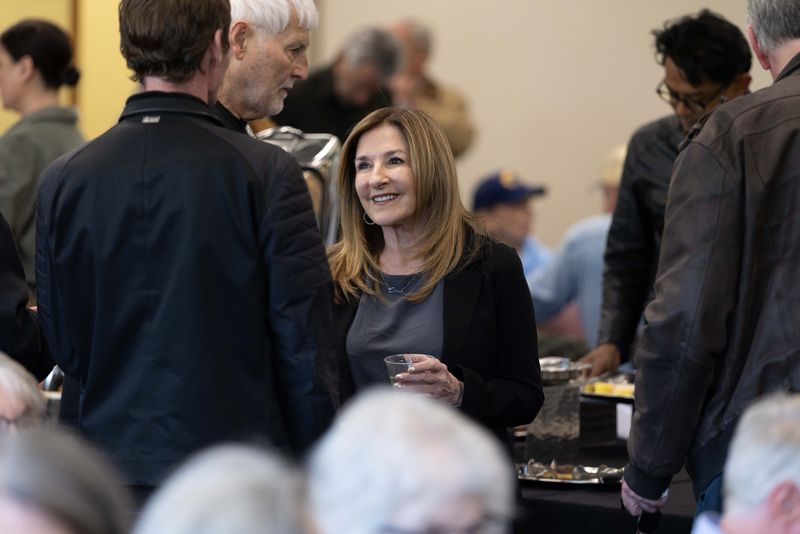 Chic Canfora, sister of May 4th shooting survivor Alan Canfora, mingles with guests during a reception held for the dedication of the Alan Canfora May 4 Collection at Kent State University on May 3, 2026.