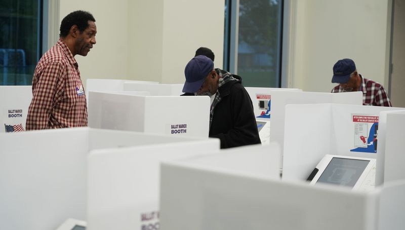 An election poll worker help voters on May 5, 2026 at the Linden Community Center in Columbus.