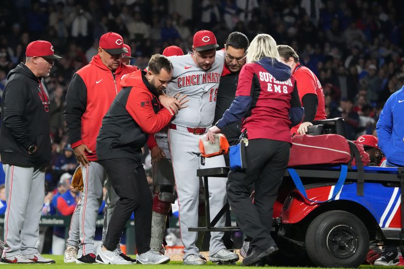 Reds pitcher Emilio Pagan is helped off the field after throwing one pitch in the ninth inning against the Chicago Cubs at Wrigley Field on May 5. Pagan has been struggling with a 6.53 ERA and six saves in nine games over 14 appearances.
