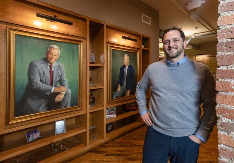 Dan Crane is the fourth-generation president and CEO of Crane Group. Behind him are portraits of second-generation leaders Bob (left) and Jim Crane.
