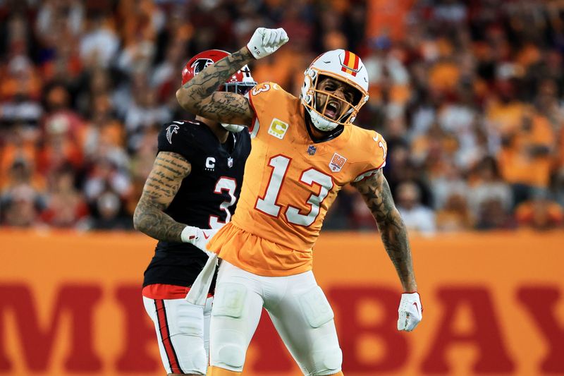 Dec 11, 2025; Tampa, Florida, USA; Tampa Bay Buccaneers wide receiver Mike Evans (13) reacts after catching a pass against Atlanta Falcons safety Jessie Bates III (3) (obscured) during the third quarter at Raymond James Stadium. Mandatory Credit: Kim Klement Neitzel-Imagn Images
