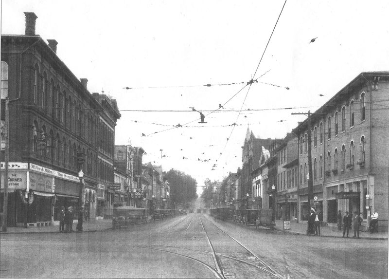 Lancaster’s Main Street is shown facing east in October 1924. Electric Trolley car service wires hang overhead and a taxi stand sign is on the sidewalk at the right in front of the Mithoff Hotel.