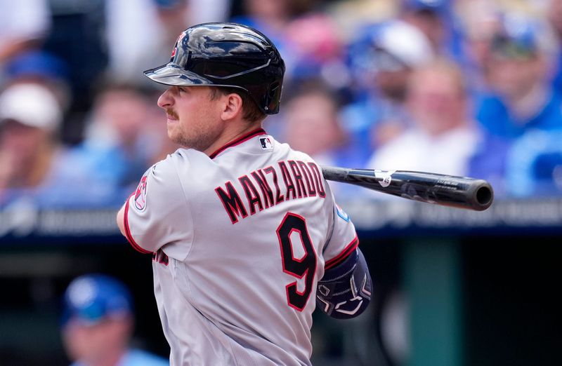 Guardians first baseman Kyle Manzardo hits an RBI double in the first inning against the Royals, May 7, 2026, in Kansas City, Missouri.