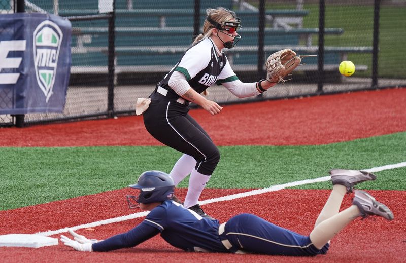 University of Akron’s Meagan Lee slides safely into third on a sarifice fly ball as Ohio University third base player takes the throw in the first inning of a MAC Tournament game at Firestone Stadium in Akron on May 7, 2026.