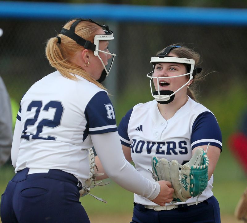 Rootstown pitcher Makensea Bittner, facing, celebrates an out with first baseman Kaitlyn Hammerschmidt during the fifth inning of a high school softball game, May 7, 2026, in Rootstown, Ohio.