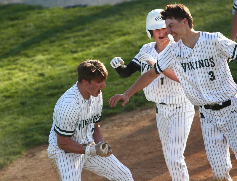 Northridge's Riley Reeves, left, celebrates scoring the game-winning run following the Vikings' 8-7 victory against visiting Johnstown on May 7, 2026.