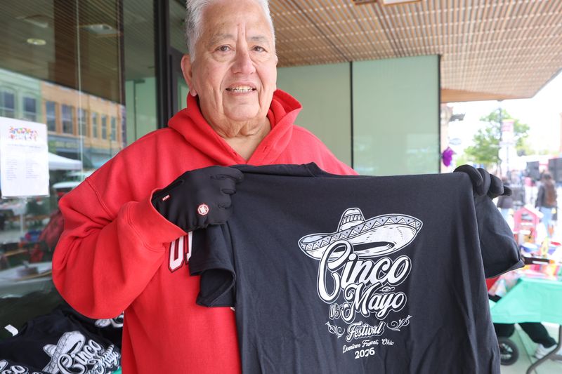 Henry Cruz shows off the 8th annual Fremont, Ohio, Cinco de Mayo Festival t-shirt.