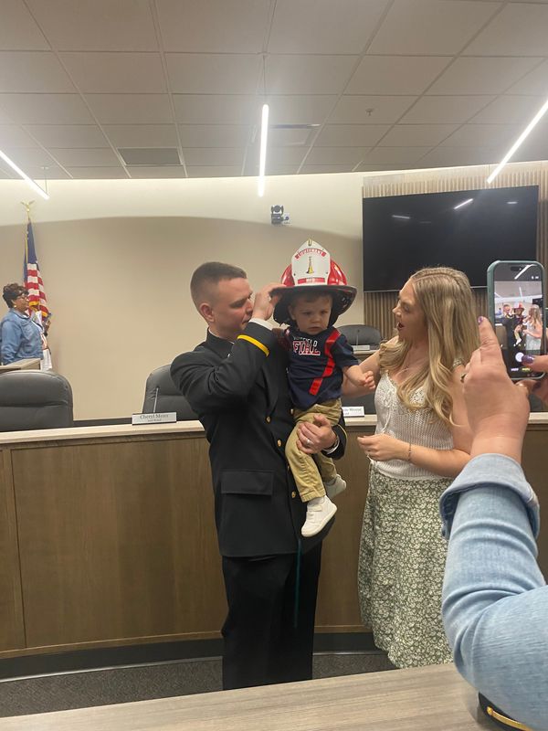 Newly sworn-in Mansfield Fire Department Lt. Adam Compton is joined by his wife Reagan and son Sterling after his promotion ceremony Friday at Mansfield City Council Chambers.