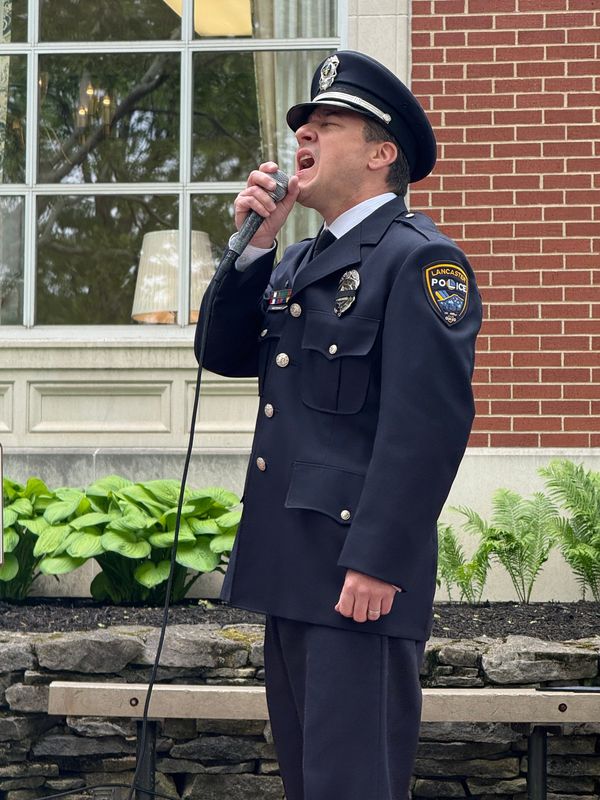 City police officer Mike Jones sings the national anthem on May 8, 2026, at the annual fallen police officers memorial in downtown Lancaster.