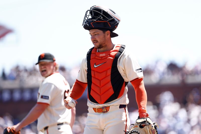 Giants starting pitcher Logan Webb returns to the mound behind catcher Patrick Bailey after the Los Angeles Dodgers scored a run during the fourth inning, April 23, 2026, in San Francisco.