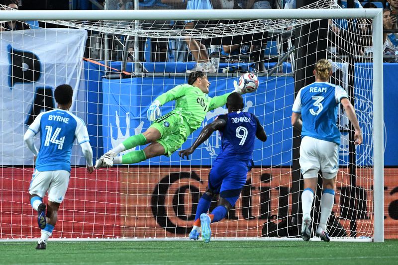 Charlotte FC goalkeeper Kristijan Kahlina can't quite make the save on a shot from FC Cincinnati forward Kévin Denkey in the first half at Bank of America Stadium.