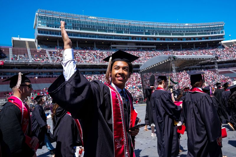A graduate waves to family members during Ohio State University’s 2026 spring commencement ceremony at Ohio Stadium on Sunday, May 10, 2026 in Columbus, Ohio.