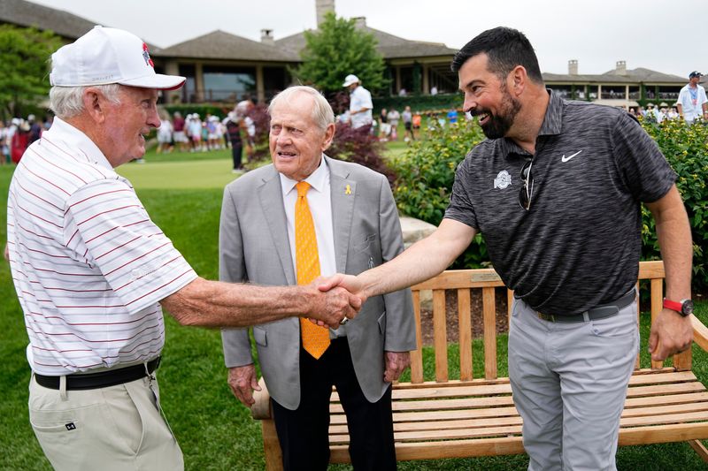 Jack Nicklaus (center) talks to Ohio State football coach Ryan Day (at right) and former coach John Cooper during a practice day for the Memorial Tournament at Muirfield Village Golf Club.
