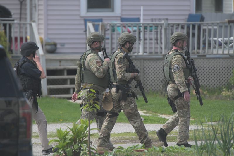 A heavy law enforcement presence closed off East Warren Street in Bucyrus on Monday as officers communicated and surrounded an armed suspect barricaded in a home.