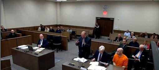 Sean Higgins, right, in orange jumpsuit, sits with his defense team as one of his attorneys, Richard Klineburger, argues during a May 11 hearing in a New Jersey courtroom. Higgins is accused of fatally striking former Columbus Blue Jacket Johnny Gaudreau and his brother, Matthew, in a Aug. 29, 2024, crash.