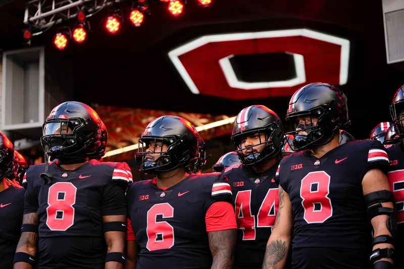 Sep 24, 2022; Columbus, Ohio, USA; Wearing black uniforms, the Ohio State Buckeyes prepare to take the field for warm-ups prior to the NCAA Division I football game against the Wisconsin Badgers at Ohio Stadium. Mandatory Credit: Adam Cairns-The Columbus Dispatch

Ncaa Football Wisconsin Badgers At Ohio State Buckeyes