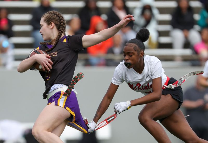 Canton McKinley’s Nevaeh Ingram, right, stops Berkshire’s Kelly McCandless during an OHSAA girls flag football regional game, May 11, 2026, in Akron.