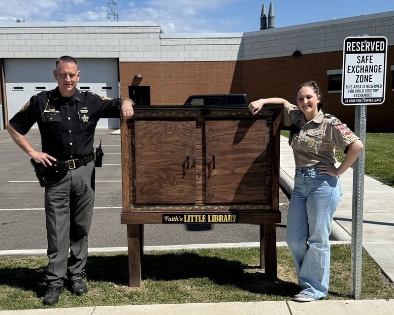 Coshocton County Sheriff Chris Walters with scout Faith Udischas, who created Faith's Little Library as her Eagle Scout project.