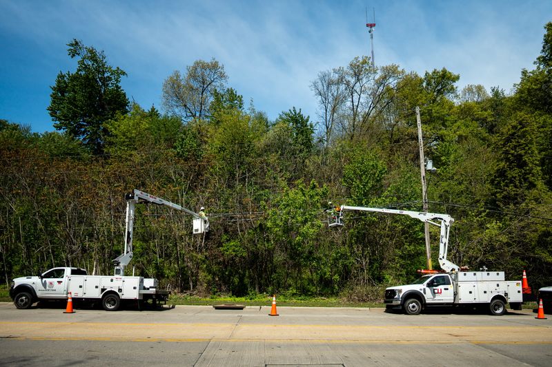 Line workers from Spectrum attend to severed communication cables along the 1500 block of Vernon Odom Blvd, between Akron Family Dental and Primo’s Deli, May 12, 2026, in Akron, Ohio.