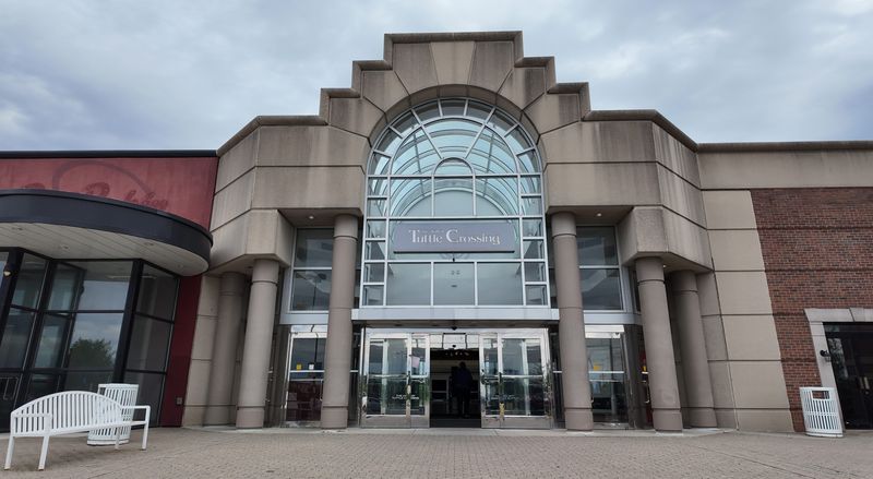 One of the main entrances to The Mall at Tuttle Crossing on May 8, 2026. The mall is an enclosed regional shopping mall in northwest Columbus, near the interchange of I‑270 and Tuttle Crossing Boulevard. While it carries a Dublin mailing address, it sits within Columbus city limits. It opened on July 24, 1997, during the peak era of new suburban malls. At its opening, it was one of the largest enclosed malls in Central Ohio by store count and floor area, spanning roughly 1.1 million square feet across two levels. The mall was developed by a joint venture between Taubman Centers and The Georgetown Company and debuted with major department store anchors including Sears, Lazarus, Marshall Field’s, and JCPenney.