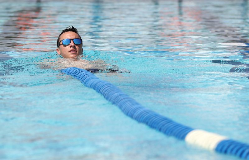 Lead lifeguard Tyler Mordarski installs lane lines in a swimming pool at the Hilliard Family Aquatic Center in preparation for the pool's reopening May 19.