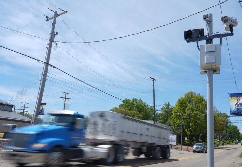 Traffic flows through East Canton on West Nassau Street under the watch of a traffic photo enforcement camera.
