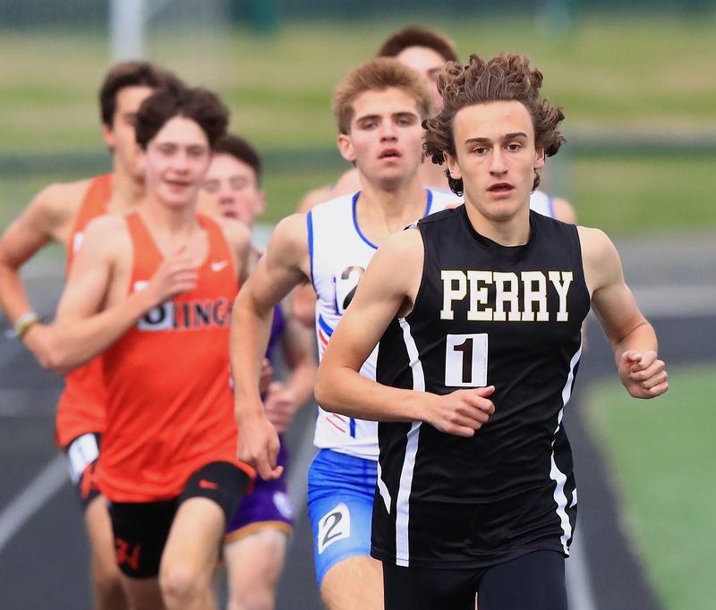 Perry's Justus Detter leads the pack in the boys 1,600 meters during the 2026 Federal League Championship at GlenOak High School, Wednesday, May 13, 2026.