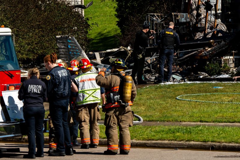 Emergency personnel work the scene of a small plane crash May 14, 2026, on Canterbury Circle, in Akron, Ohio.