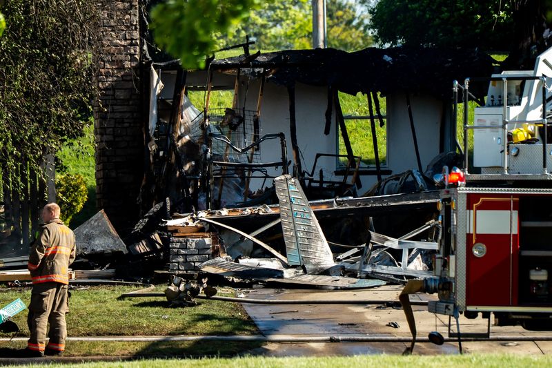 The remnants of a single-engine plane can be seen where it crashed into a home May 14 on Canterbury Circle in Akron.