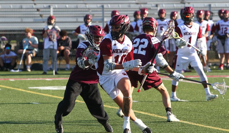 Newark's Colton Loudermilk maneuvers around a defender during the Wildcats' 15-4 victory against visiting Canal Winchester in a Division I tournament match at White Field on May 14, 2026.