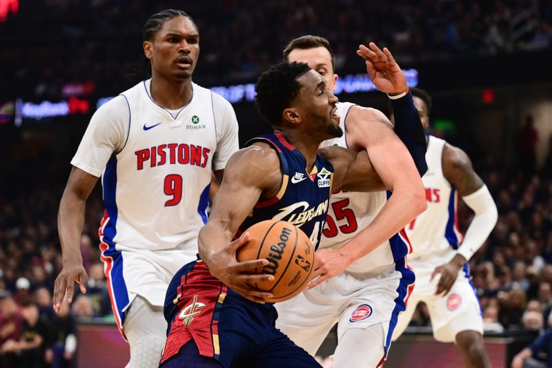 Cavaliers guard Donovan Mitchell drives to the basket against Detroit Pistons forward Duncan Robinson during the first half in Game 6 of a second-round playoff series, May 15, 2026, in Cleveland
