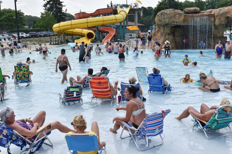 Season pass holders cool off at the Water Works Family Aquatic Center amid 92 degree heat on Monday, June 17, 2024, in Cuyahoga Falls, Ohio.