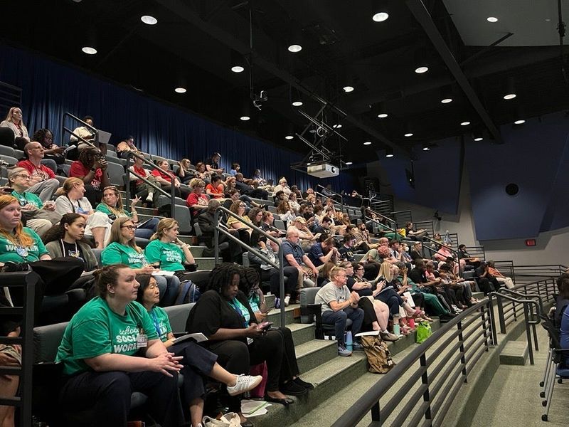 Cincinnati Public School staffers, union members and parents fill the audience at the May 18 board meeting, where the district proposed a list of personnel cuts.