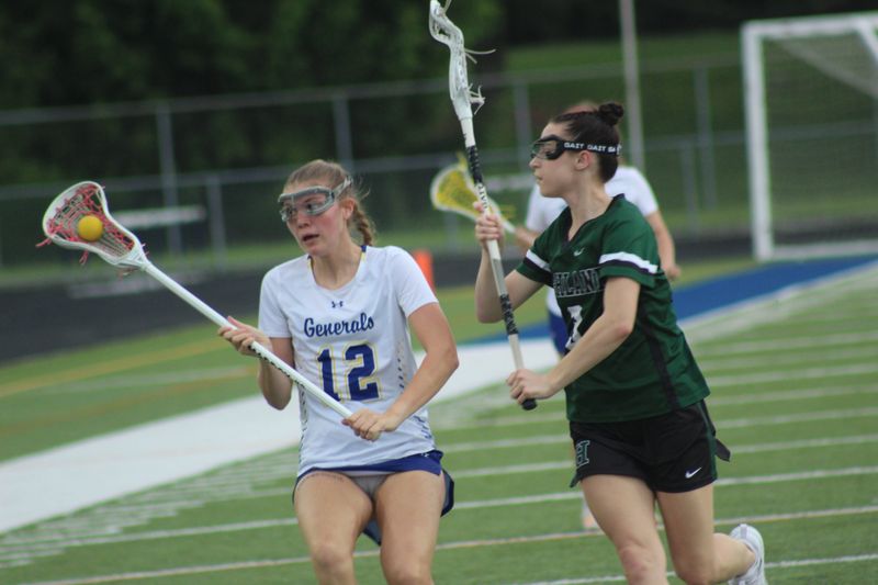 Wooster midfielder Lyla Smith has the ball as a Medina Highland player defends her. Wooster defeated Medina Highland 14-6 in a Division II sectional final Monday evening at Wooster High School.