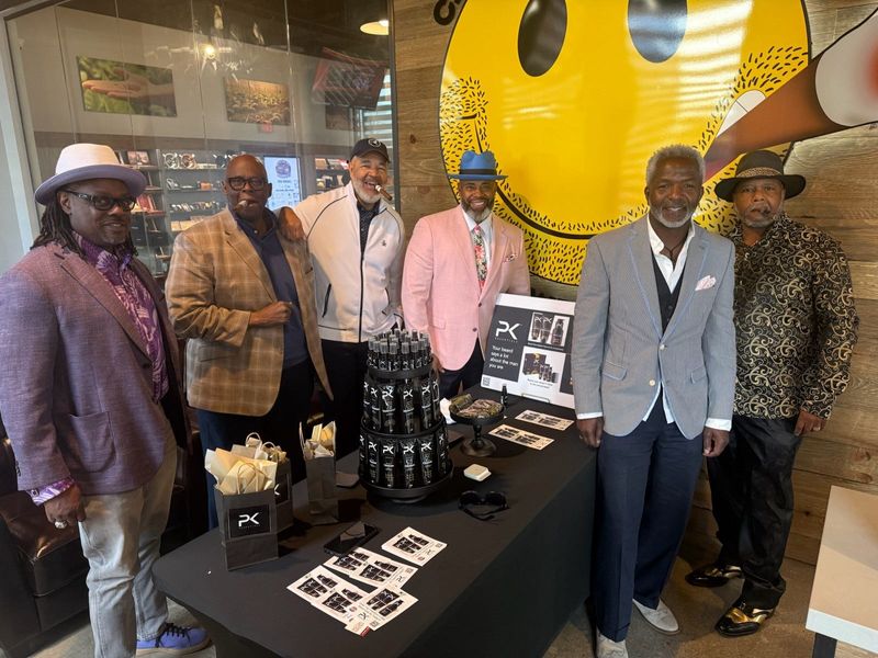 That's me, Enquirer reporter Randy Tucker in my white merino-blend track jacket, in the center of a circle of nattily dressed cigar aficionados at Cigars International Superstore at Newport on the Levee.