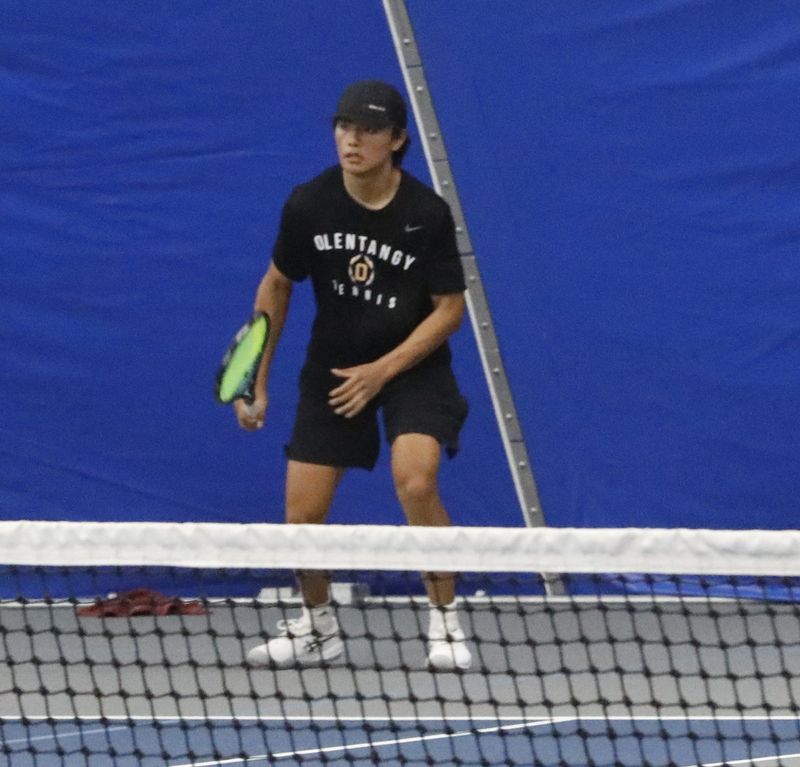 Olentangy's Gavin Cheung prepares for a serve from Olentangy Orange's Luke Rutherford during a Division I district quarterfinal match May 20 at Olympic Indoor Tennis.