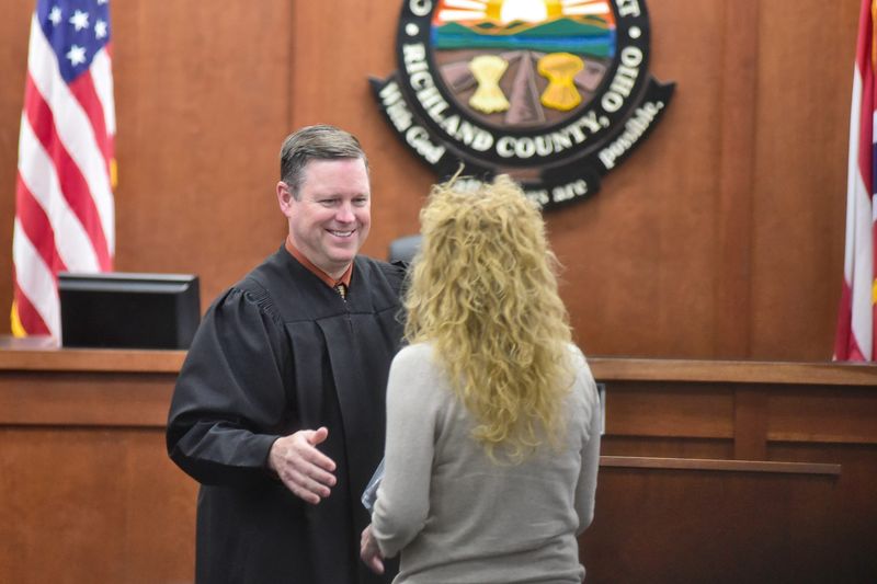 Richland County Common Pleas Judge Brent Robinson shakes the hand of a drug-court graduate May 20, 2026.