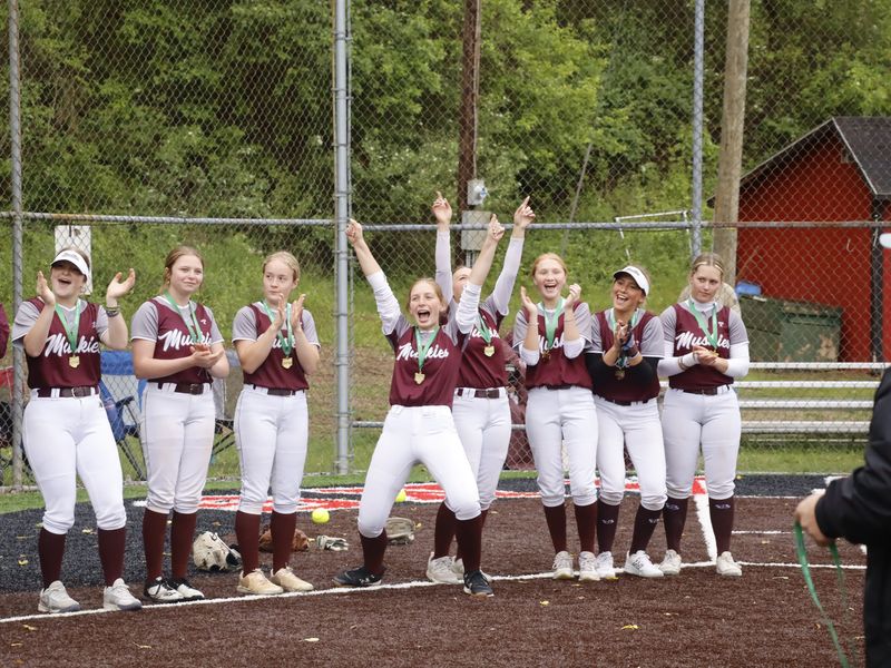 John Glenn players continue to celebrate their Division IV district championship as they line up for the awards presentation after upsetting No. 1 seed Beaver Local 9-0 in the championship game on Wednesday, May 20, 2026 at Tusky Valley High School. The Muskies improve to 25-5 and advance to the Division IV Sweet 16 on Wednesday, May 27 at 2 p.m. at Philo High School.