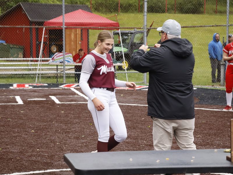 John Glenn Athletic Director Michael Dunlap presents sophomore ace Kendall Snider with her medal after the Muskies captured the Division IV district championship after upsetting No. 1 seed Beaver Local 9-0 in the championship game on Wednesday, May 20, 2026 at Tusky Valley High School. The Muskies improve to 25-5 and advance to the Division IV Sweet 16 on Wednesday, May 27 at 2 p.m. at Philo High School.